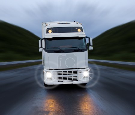 Motion of white truck on the night road