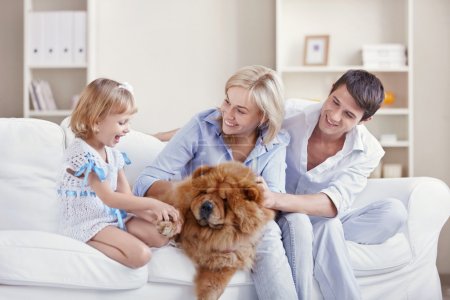 Young family with a dog at home