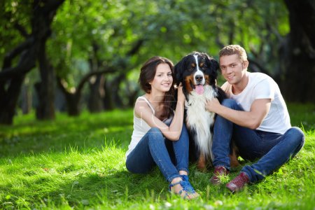 A nice couple with a dog in the park