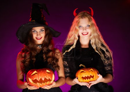 Halloween witches with pumpkins
