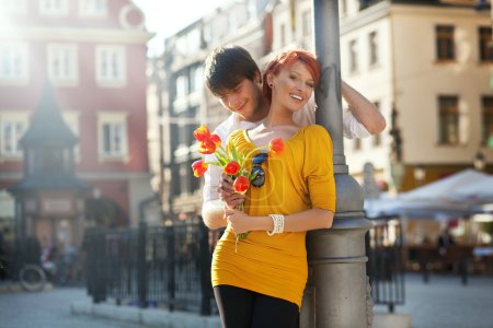 Young couple with flowers, outdoors
