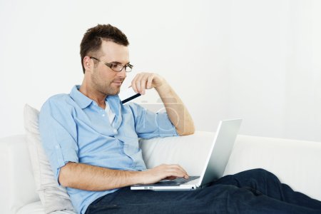 Man using credit card and laptop