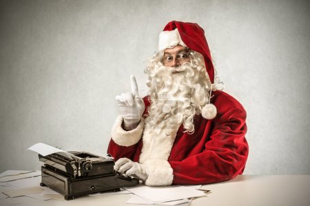 Santa klaus using a typewriter