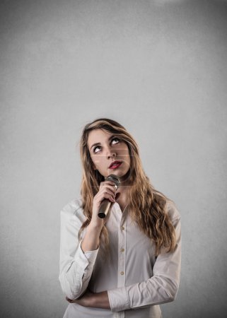Young woman speaking through a microphone