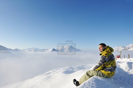 Man at mountains in clouds