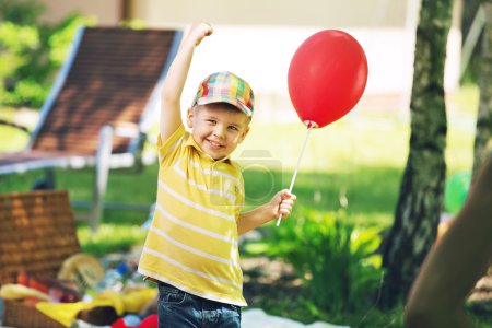 Smiling boy with red baloon