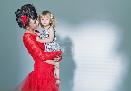 Cute little girl hugged by her mother