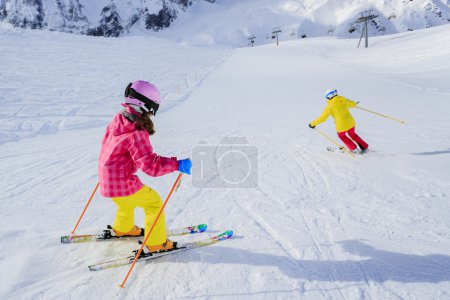 Ski, skiers on ski run - female skiers skiing downhill