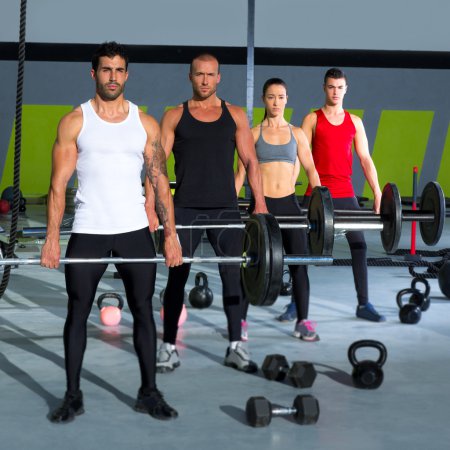 gym group with weight lifting bar crossfit workout