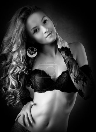 sensual blond woman in lingerie, dark background