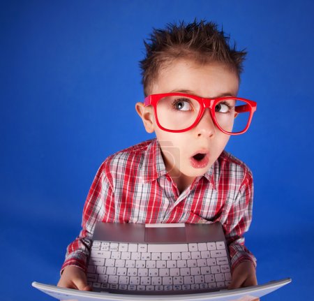 Little boy with a laptop, computer addiction concept