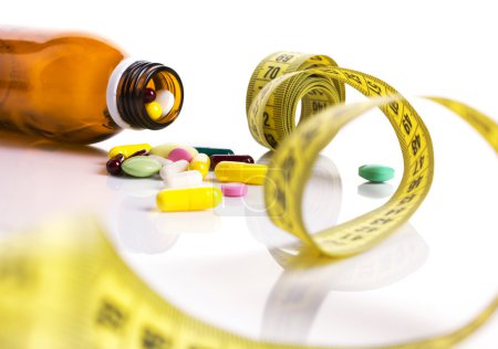 centimeter and pills for dieting concept