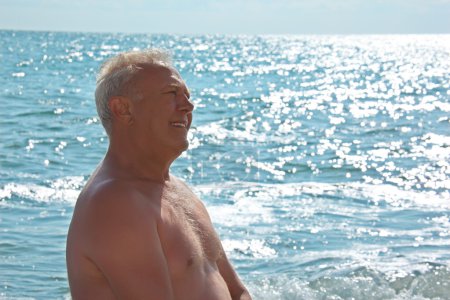 Elderly smiling man on seacoast