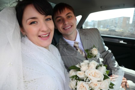 Bride with fiance in car