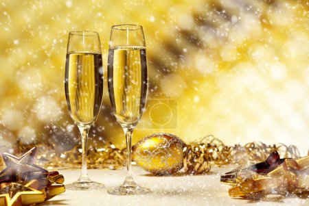 Glass of champagne against golden background