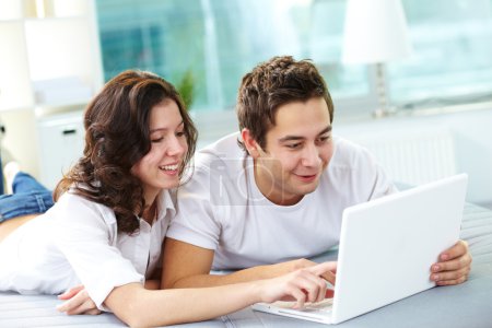 Couple using laptop