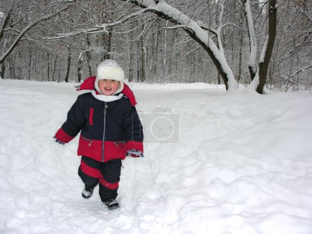 Run boy in winter wood