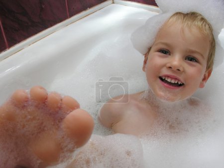 Boy in bath with leg