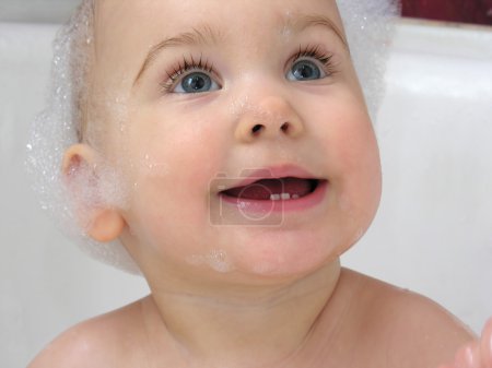 Baby in bath clouseup