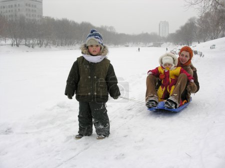 Mother with children . sled. winter