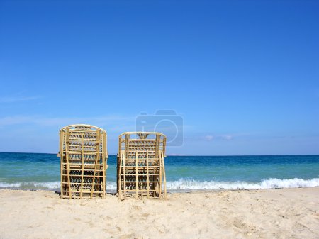 Two chairs. beach.