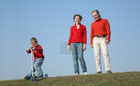 Family with boy with scooter
