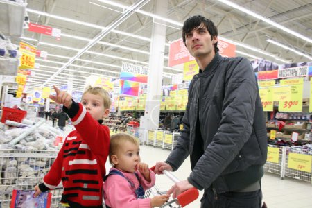 Father with children in shop