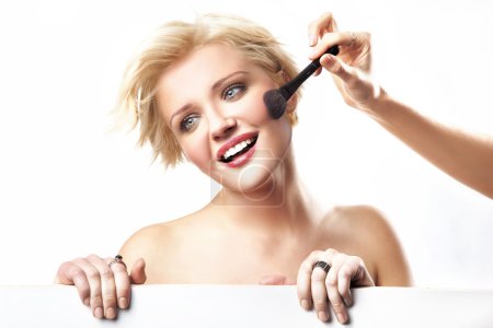 Portrait of a woman doing make up