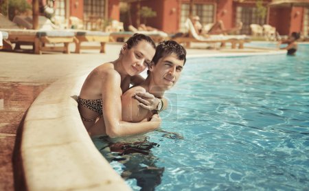 Young couple kissing in a swimming pool