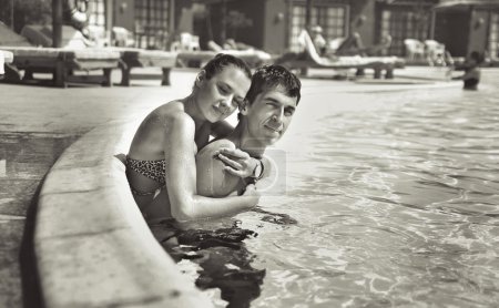 Young couple kissing in a swimming pool