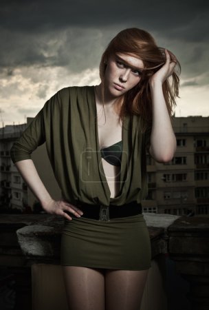 Vogue style photo of a beautiful redhead woman