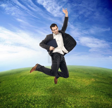 Businessman jumping on the field