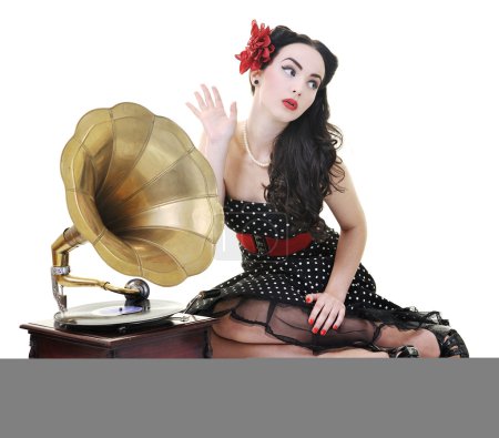 Pretty girl listening music on old gramophone