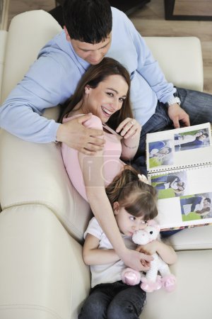 Happy family looking photos at home