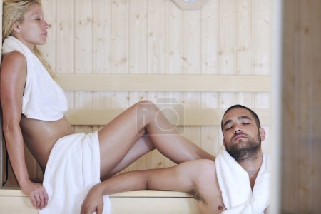 Happy young couple in sauna