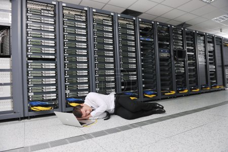 Business man practice yoga at network server room