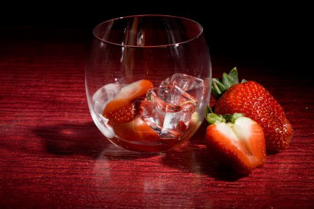 Strawberries on ice on red background - Cocktail Dessert