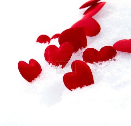 Red hearts on snow