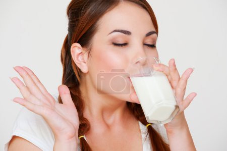 Young woman drinking milk
