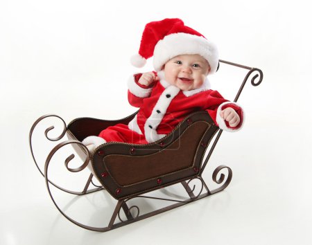 Smilng santa baby sitting in a sleigh