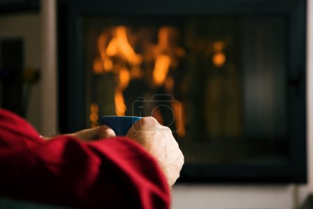 Hot drink in front of fireplace