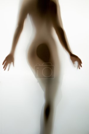 Blurred shot of sexy naked woman from back walking away