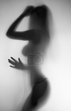 Black and white blurred photo of slim naked woman 