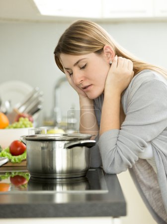 sad woman leaning on table at kitchen