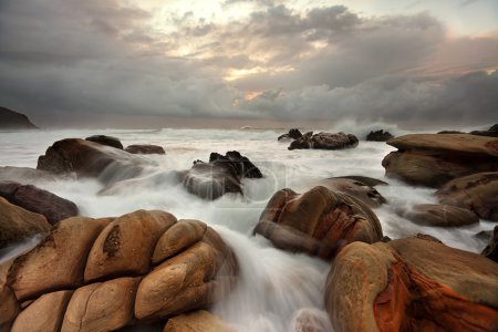Ocean surges over weathered rocks