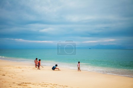 Thai children play on the beach