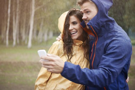 Couple looking weather forecast