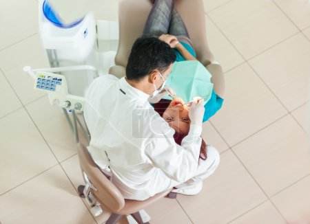 top view of asian dentist doing his job on a young asian woman