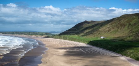 Panorama landscape Rhosilli Bay beach in Wales on Summer day