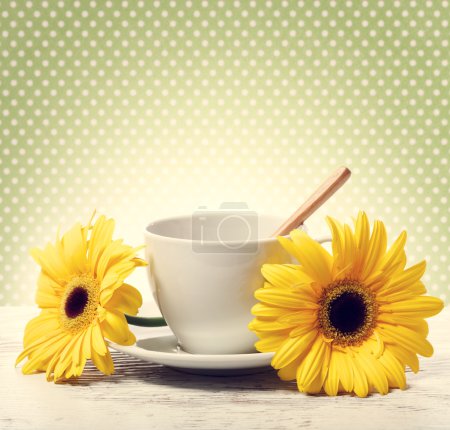 Coffee cup with big yellow gerberas